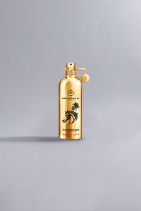 Arabians Gold luxury perfume bottle in reflective metallic gold with black horse and palm tree design, showcasing high-end fragrance elegance.