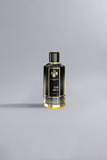 Black Vanilla Black perfume bottle with elegant black and gold design, showcasing luxury and refined style against a minimalist light gray background.
