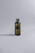 Luxury perfume bottle featuring a sleek black and gold striped design, showcasing the sophisticated Lemon Line Black Dessin fragrance.