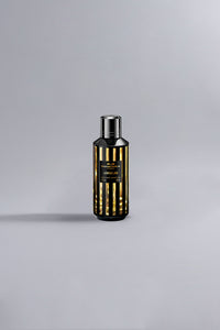 Luxury perfume bottle featuring a sleek black and gold striped design, showcasing the sophisticated Lemon Line Black Dessin fragrance.