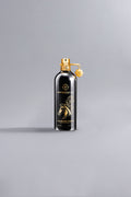 Elegant black and gold Montale Arabians Tonka Black perfume bottle with horse illustration, showcasing luxury and high fashion in a minimalist setting.