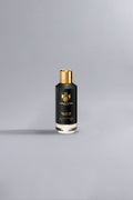 Black Gold Black luxury perfume bottle with black and gold design, standing alone on a minimalist gray background, showcasing elegant high-end fragrance packaging.