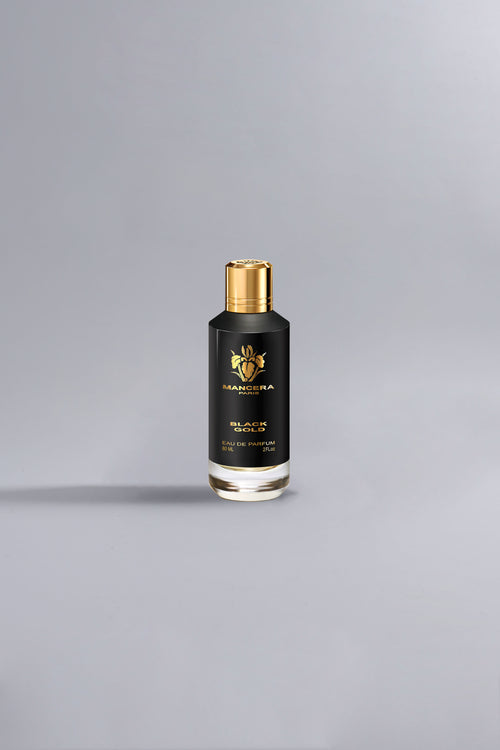 Black Gold Black luxury perfume bottle with black and gold design, standing alone on a minimalist gray background, showcasing elegant high-end fragrance packaging.