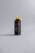 Montale Paris Oud Dream Black perfume bottle in matte black with gold accents, showcasing a luxury fragrance bottle design on a neutral background.