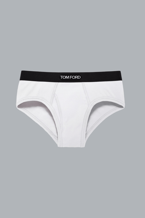 Brief White men's underwear with a black waistband featuring branding, displayed on a gray background, highlighting its clean and modern design.