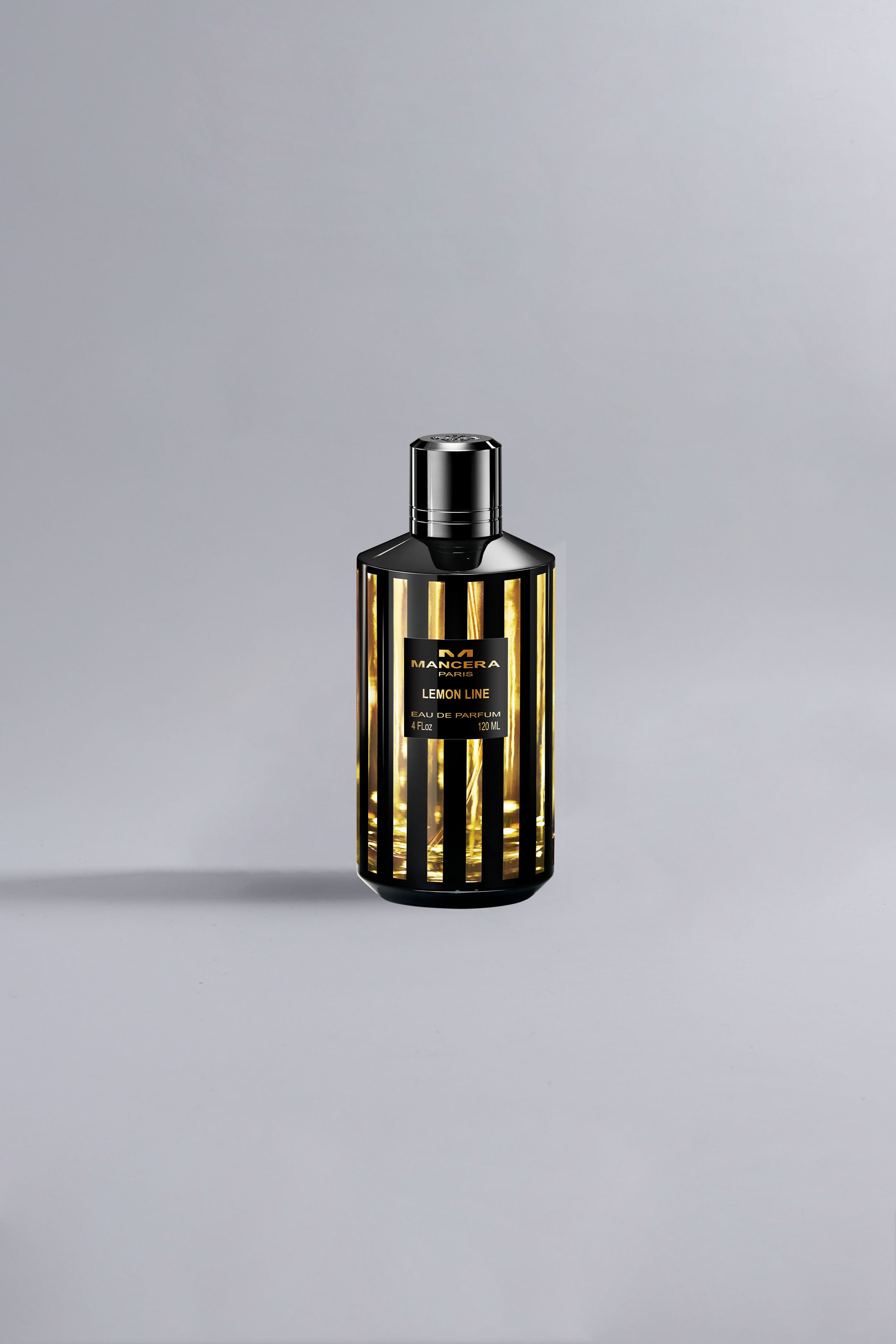 Elegant black and gold striped perfume bottle showcasing the luxurious Lemon Line Black Dessin fragrance with a sleek modern design against a neutral background.